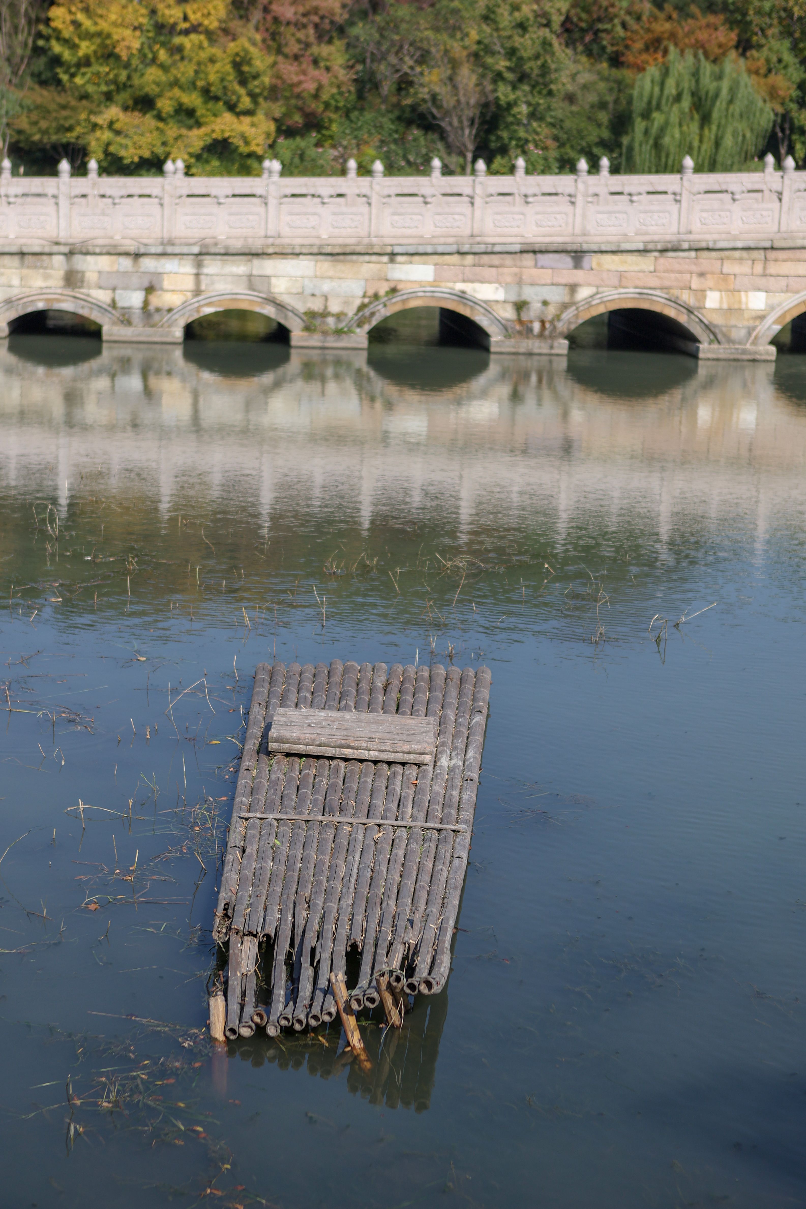 Traditional bamboo raft by historic stone bridge · Free Stock Photo