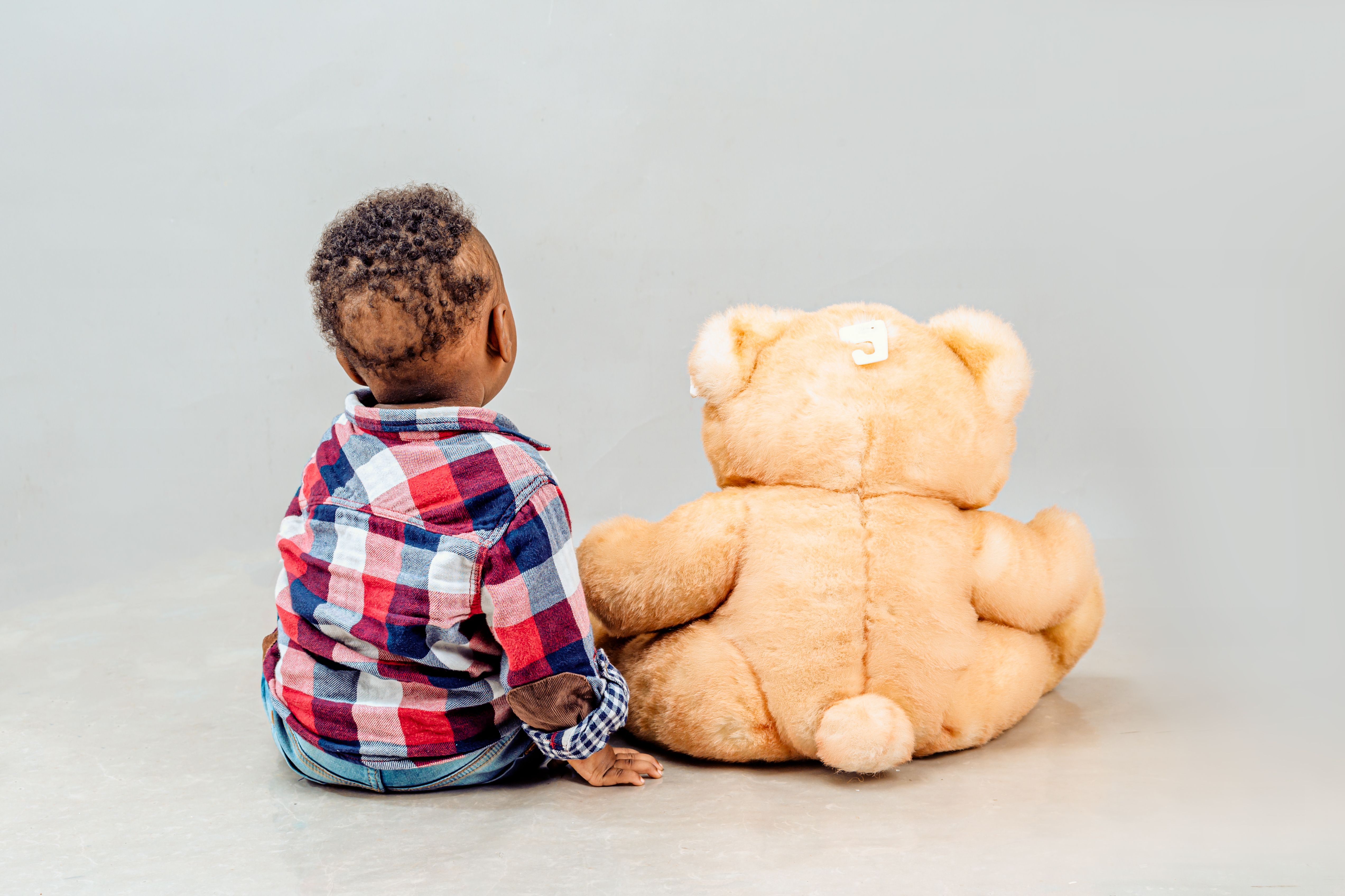 Child Sitting with Large Teddy Bear · Free Stock Photo