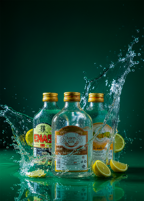 Free Three gin bottles and lemon slices with water splash on green background. Stock Photo