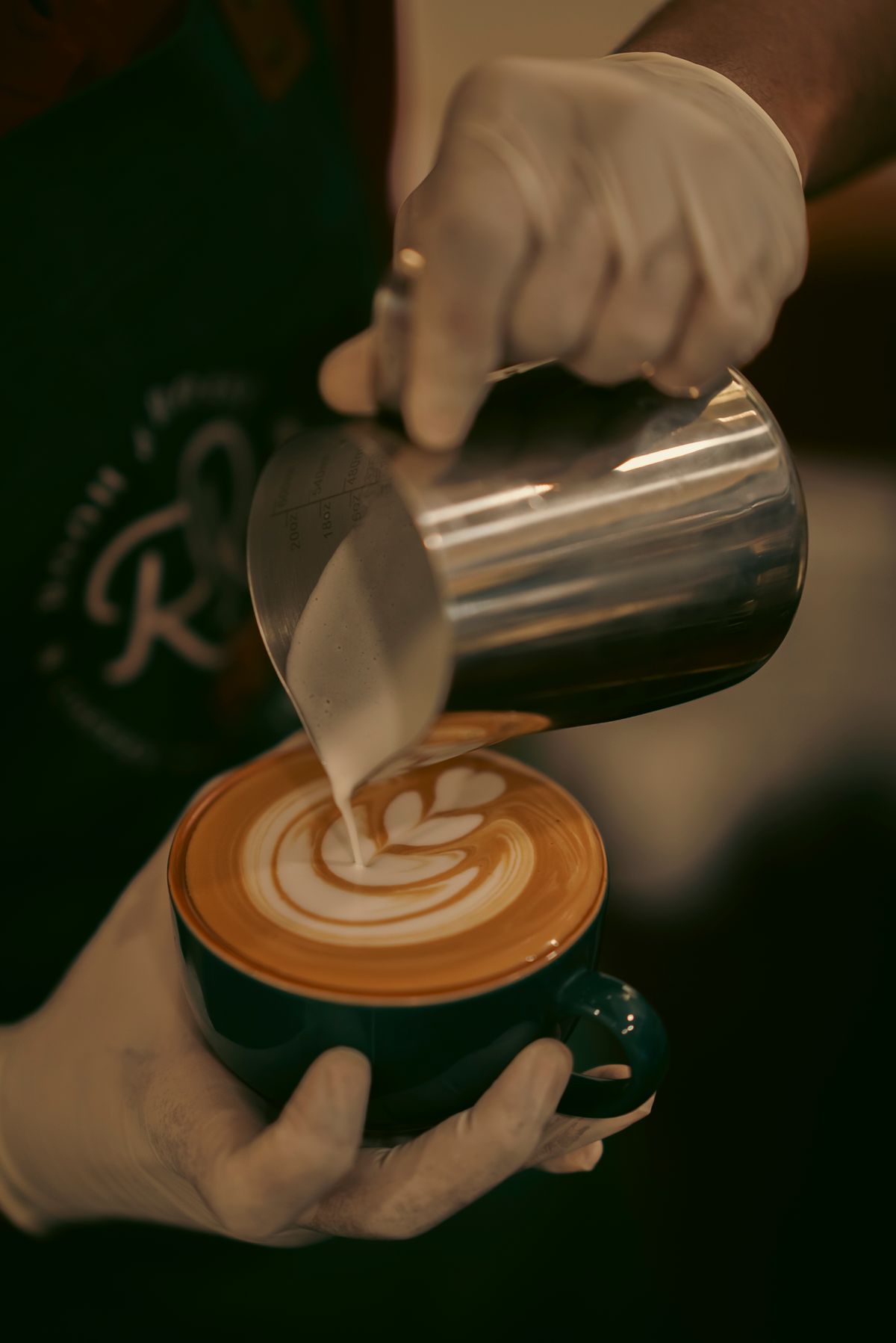 Fresh latte art being poured by a barista
