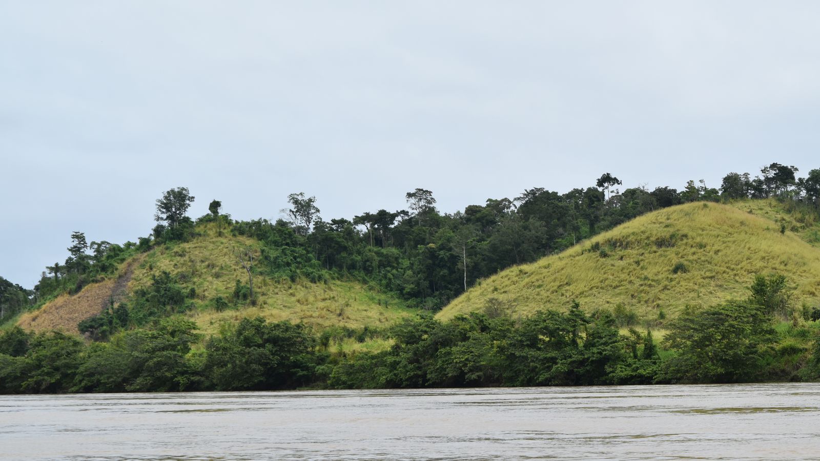 Lush tropical hills by a serene river, Central African Republic