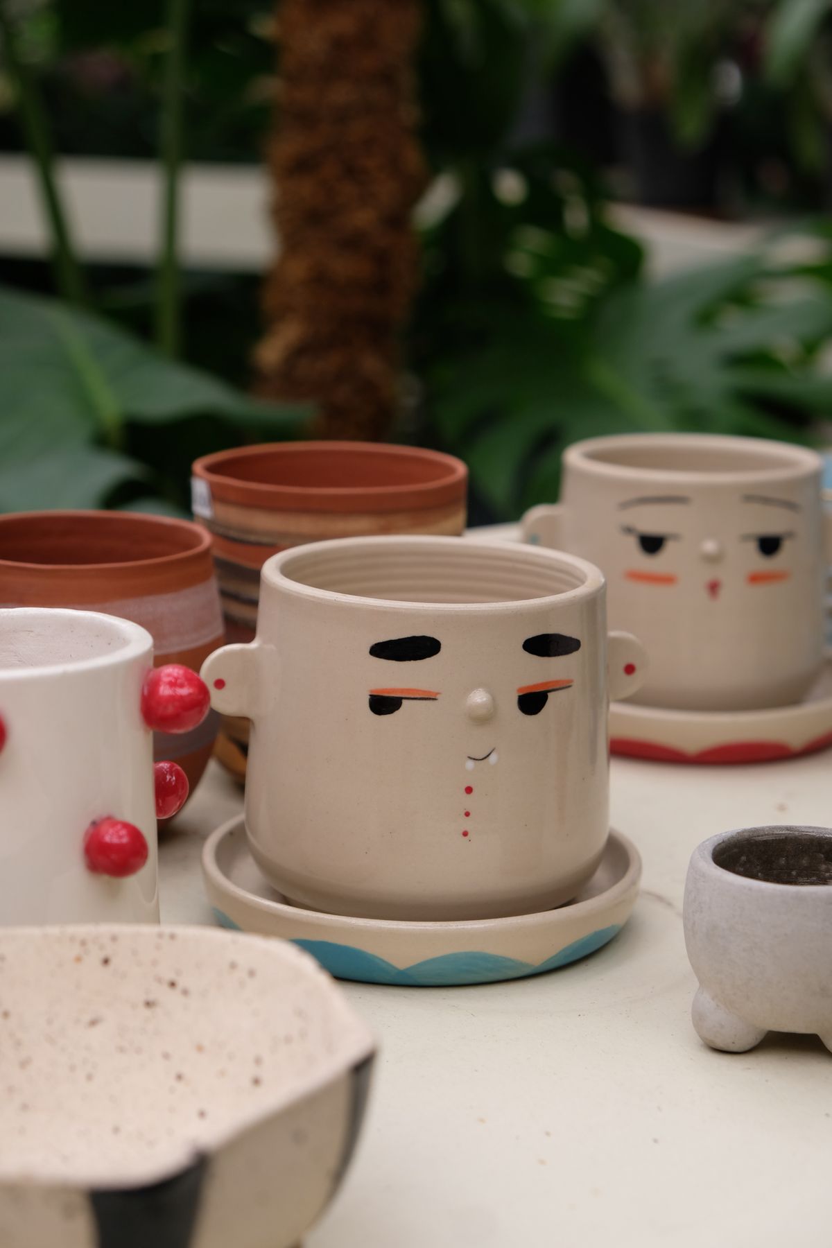Clay pot craft ideas with ceramic face planters with painted faces and ear knobs