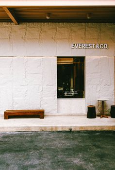 Minimalist exterior of Everest & Co. coffee shop with rustic decor in Thailand.