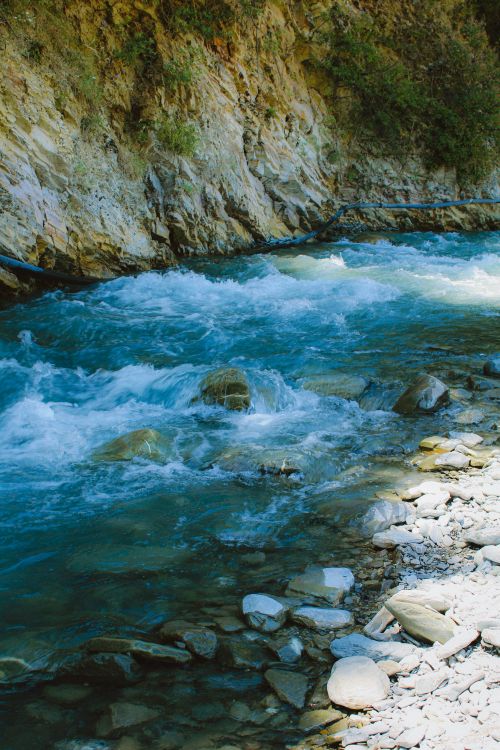 Free Beautiful river flows through rocky terrain in Gebele, Azerbaijan, showcasing nature's vibrant scenery. Stock Photo