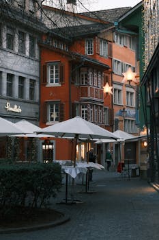 Picturesque street in Europe with colorful buildings and cozy outdoor cafes.