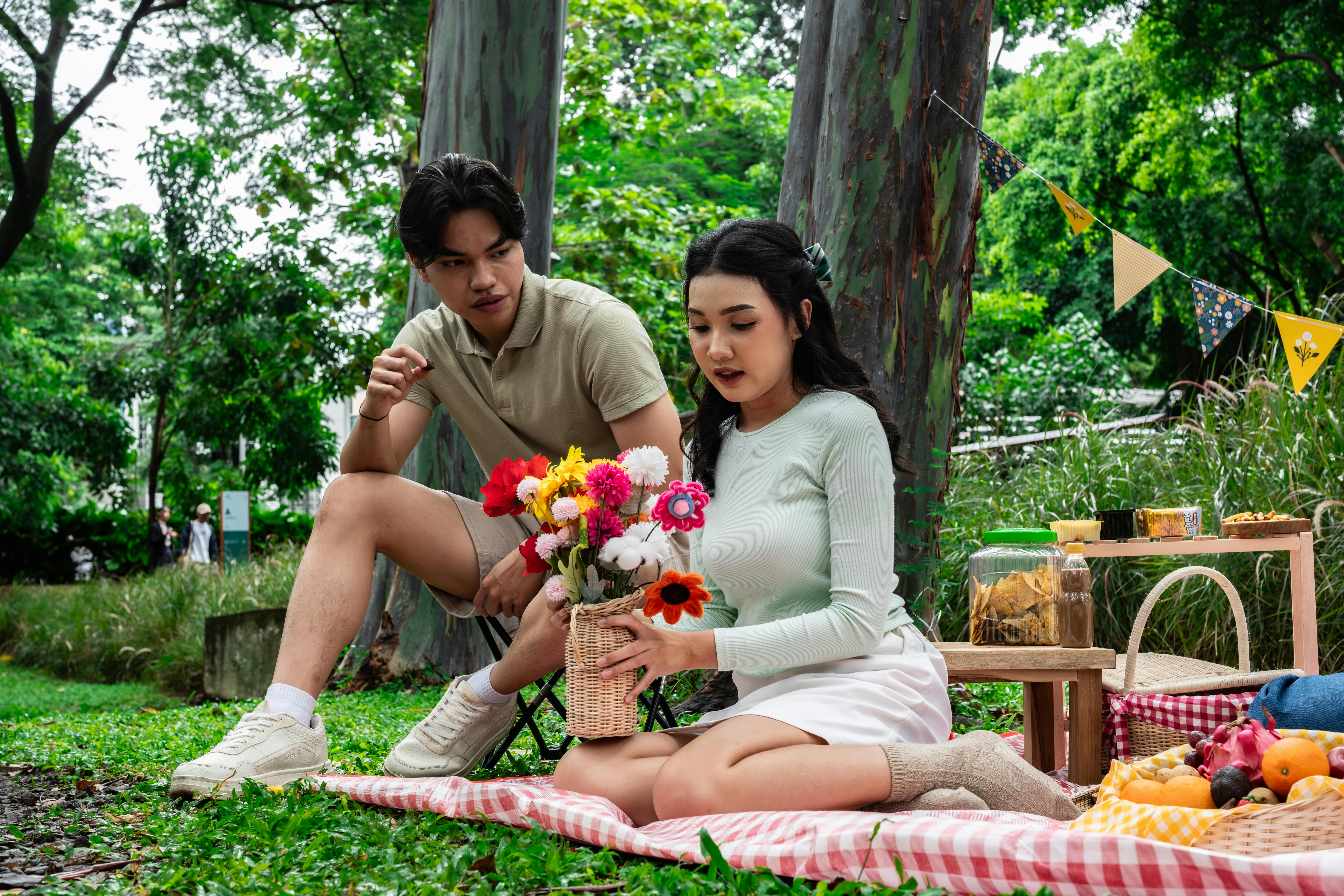 Enjoying a vibrant picnic with friends amidst lush greenery in Indonesia.