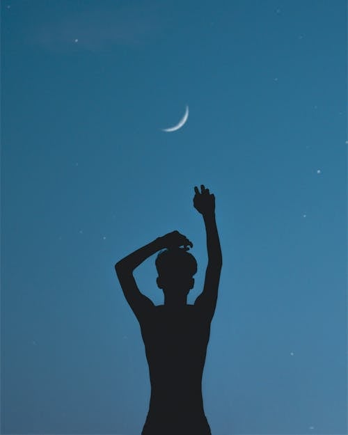 Free Silhouette of  Person Raising his Hands Stock Photo