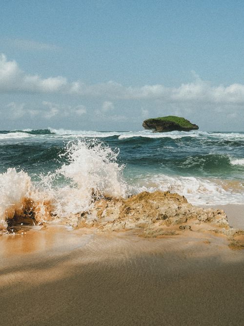 Free Captivating view of waves crashing on the rocky shore of East Java's pristine beach in Indonesia. Stock Photo