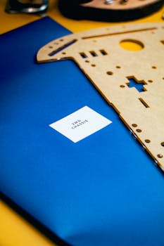 Close-up of a DIY robotics chassis kit on a vibrant blue background, highlighting innovation and technology.