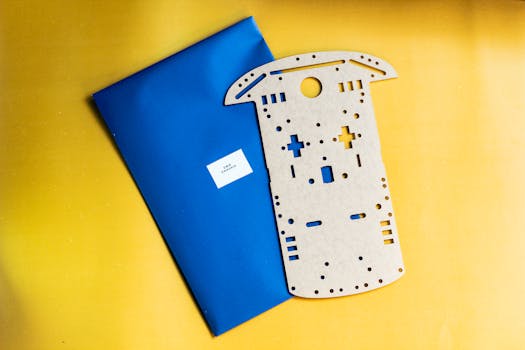 Wooden robotics kit component on a vibrant yellow and blue backdrop.