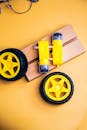Yellow Robotics Parts on Wooden Background