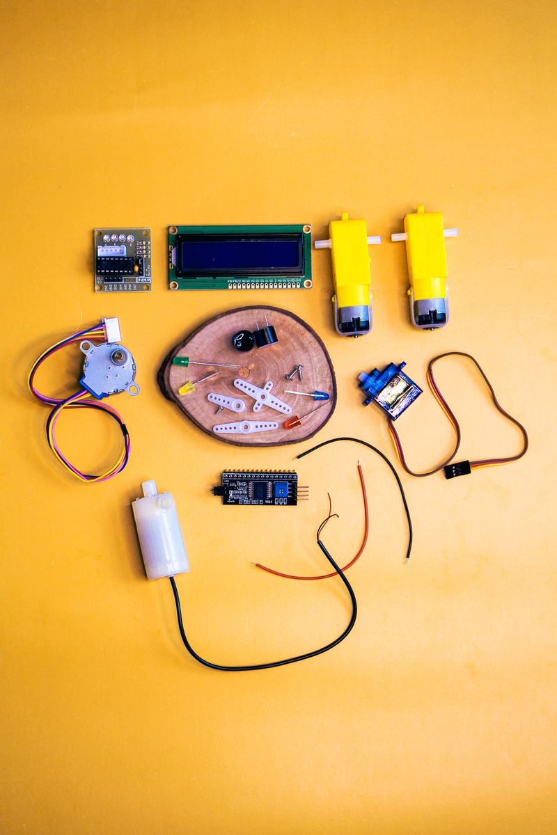 DIY Robotics Kit Components on Vibrant Yellow · Free Stock Photo