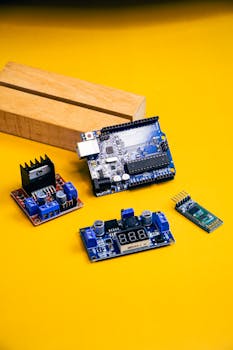 A detailed view of various robotics components set against a bold yellow backdrop, perfect for tech enthusiasts.