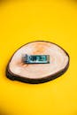 Microchip on Wooden Slice with Yellow Background