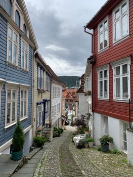 Picturesque cobblestone street with colorful wooden houses in Bergen, Norway.