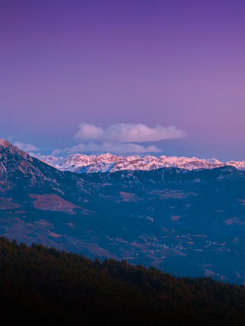 Free Breathtaking view of a snow-capped mountain range under a vibrant twilight sky. Stock Photo