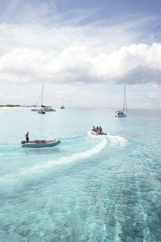 Serene view of boats sailing over turquoise waters under a blue sky.