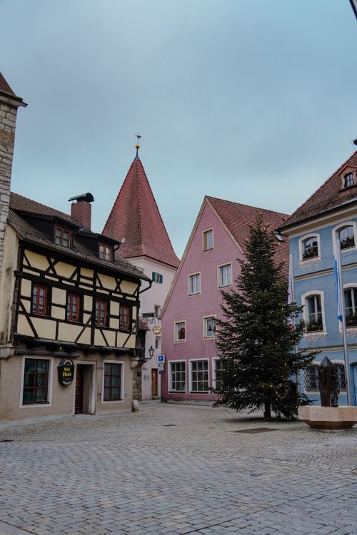 Free Charming Bavarian village street with traditional houses and a Christmas tree. Stock Photo