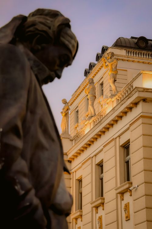Free Beautiful architectural details with a prominent statue captured at twilight in Skopje, North Macedonia. Stock Photo