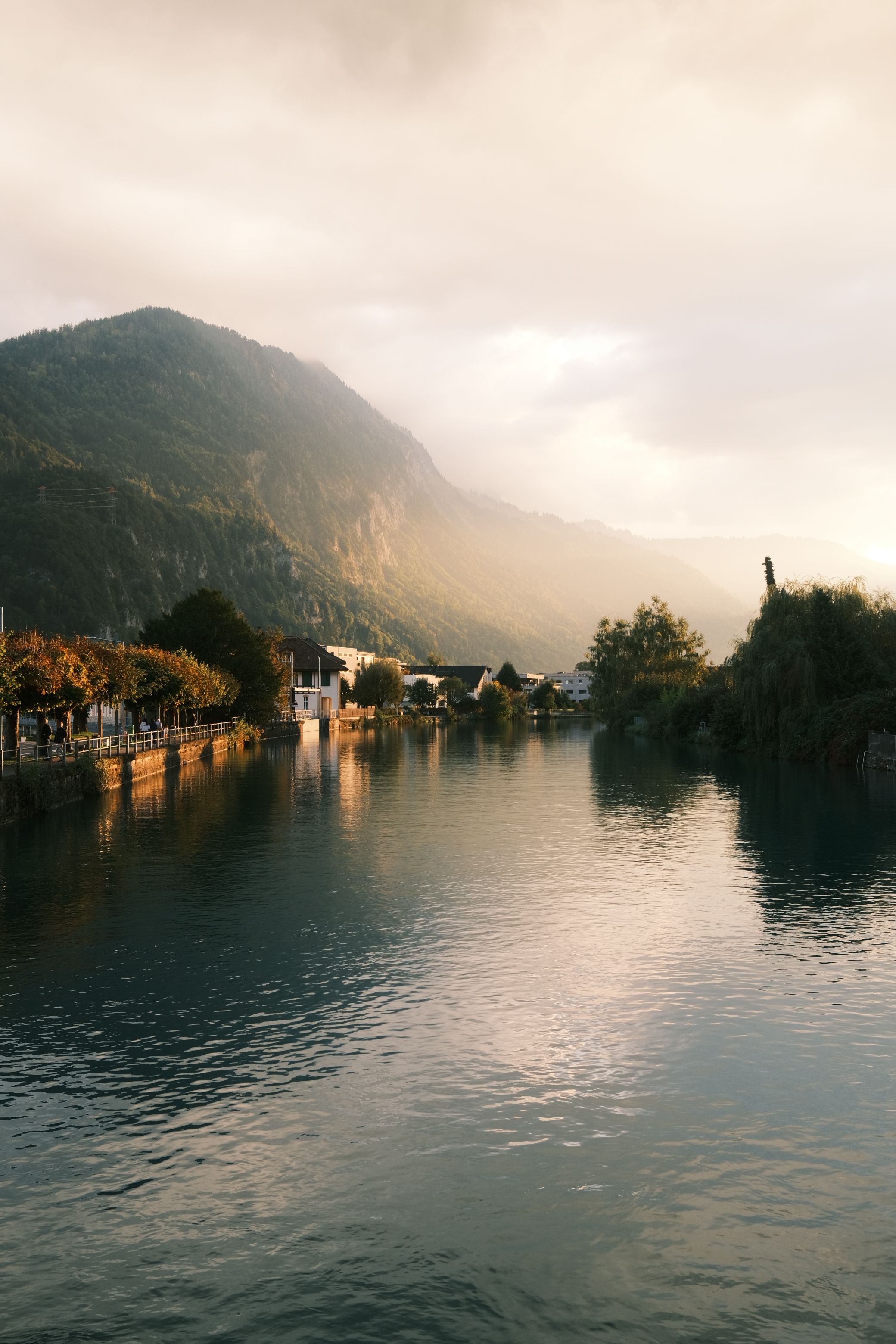 Beautiful serene river with mountain backdrop in warm evening light