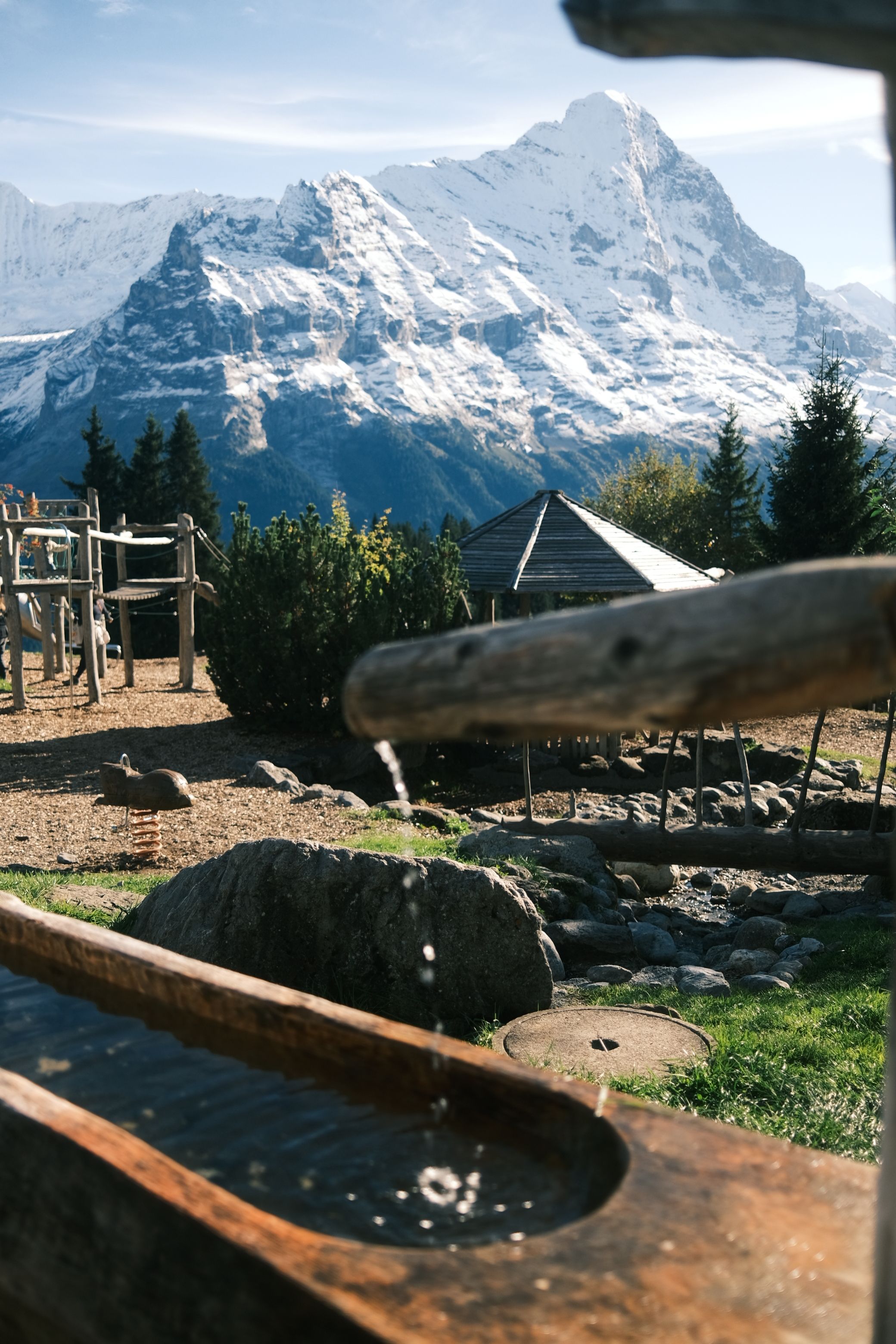 Scenic Alpine Landscape with Wooden Water Trough · Free Stock Photo