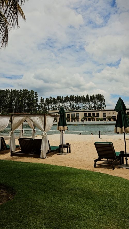 Free Luxurious poolside scene with loungers and cabanas, perfect for a summer retreat. Stock Photo