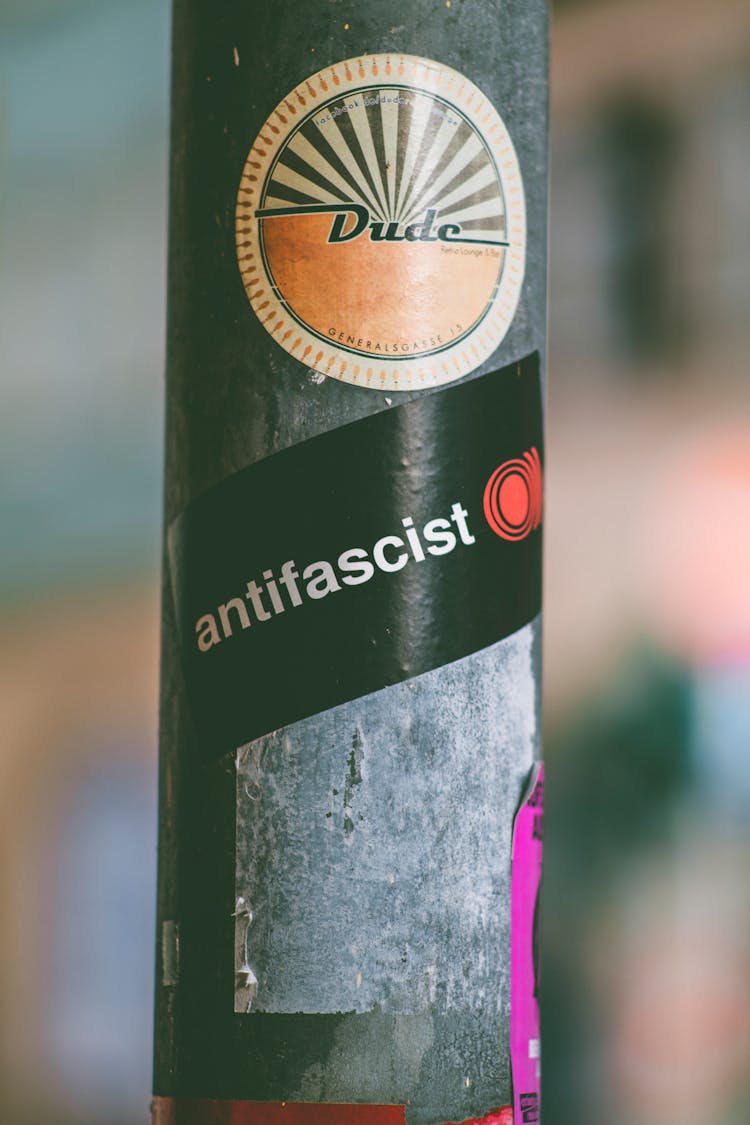 Dude And Antifascist Stickers On Pole