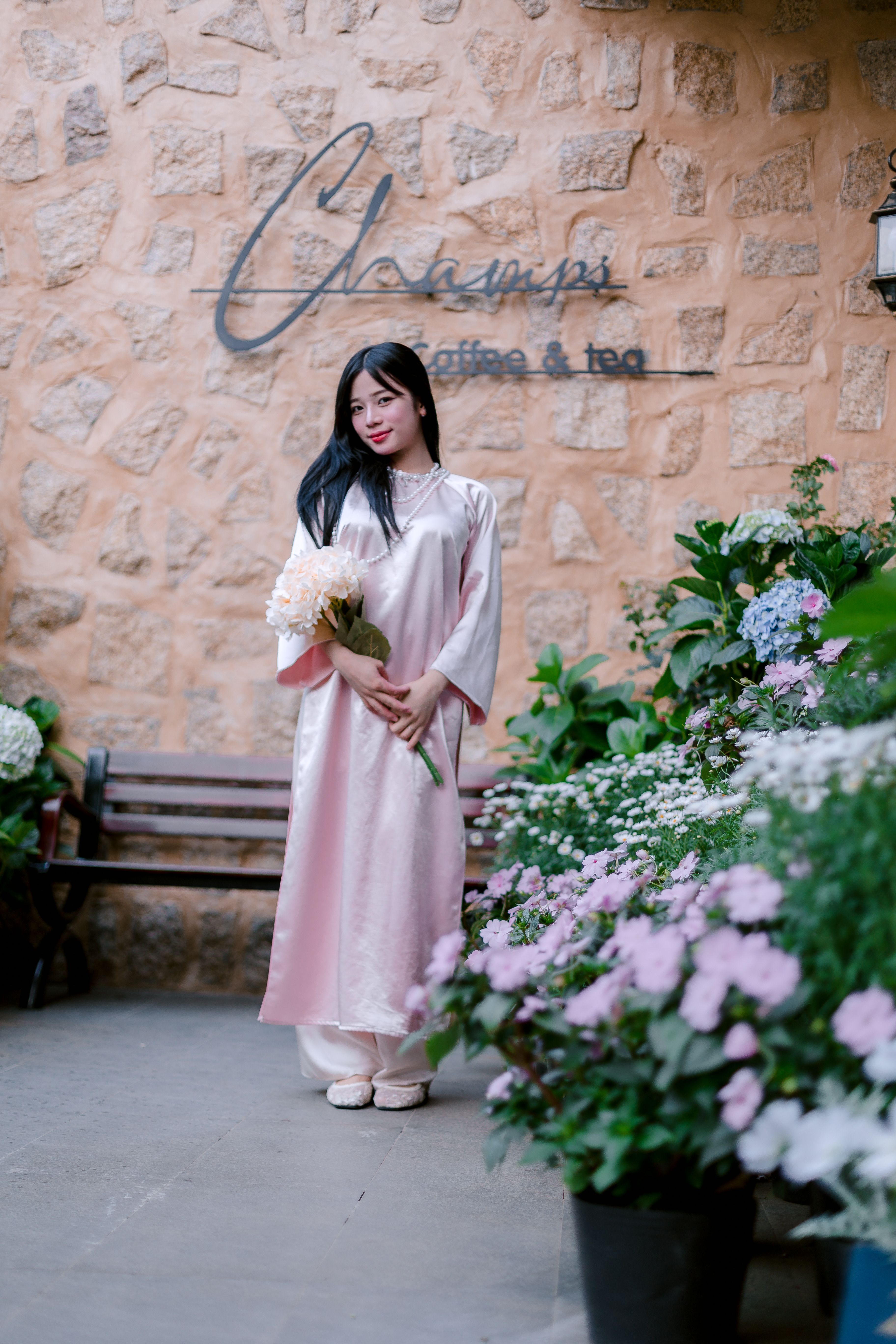 Woman in Pink Dress Holding Flowers Outdoors · Free Stock Photo