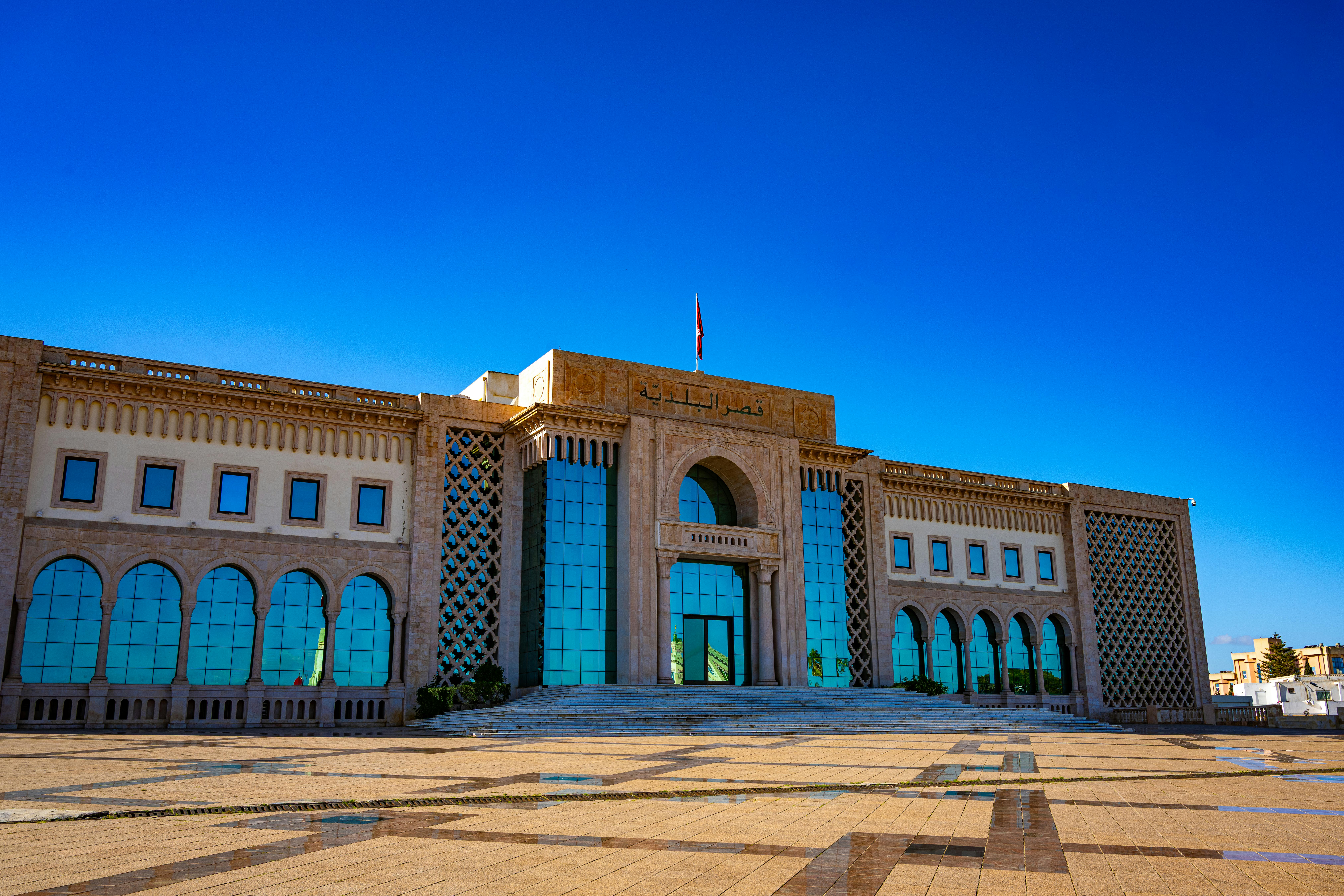 Stunning architectural landmark of Tunisia's government building under a clear blue sky.