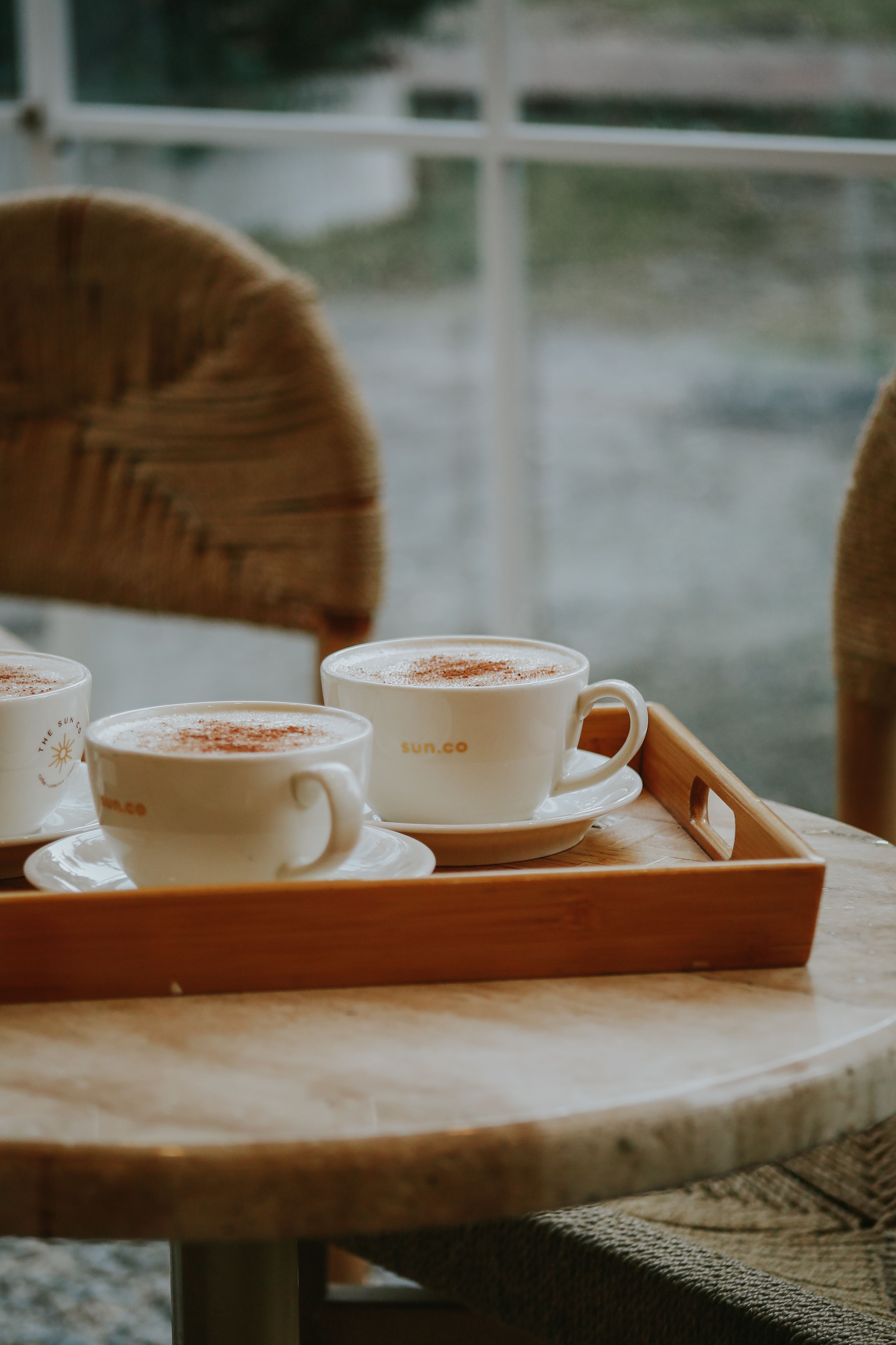 Coffee cups on a wooden tray in a cafe