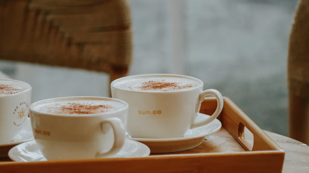 Coffee cups on a wooden tray in a cafe