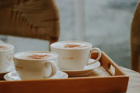 Coffee cups on a wooden tray in a cafe