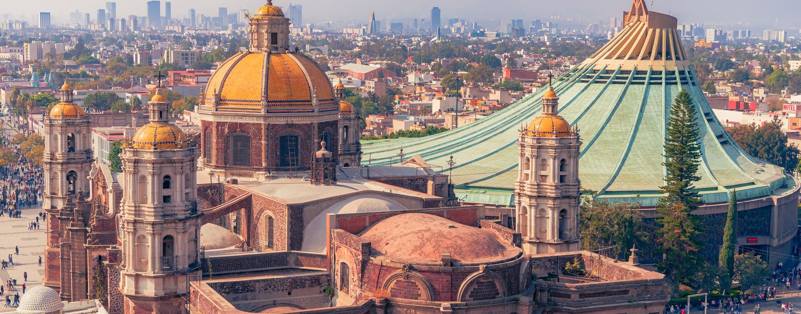 Aerial view of the historic Basílica de Santa María de Guadalupe and the cityscape of Mexico City.