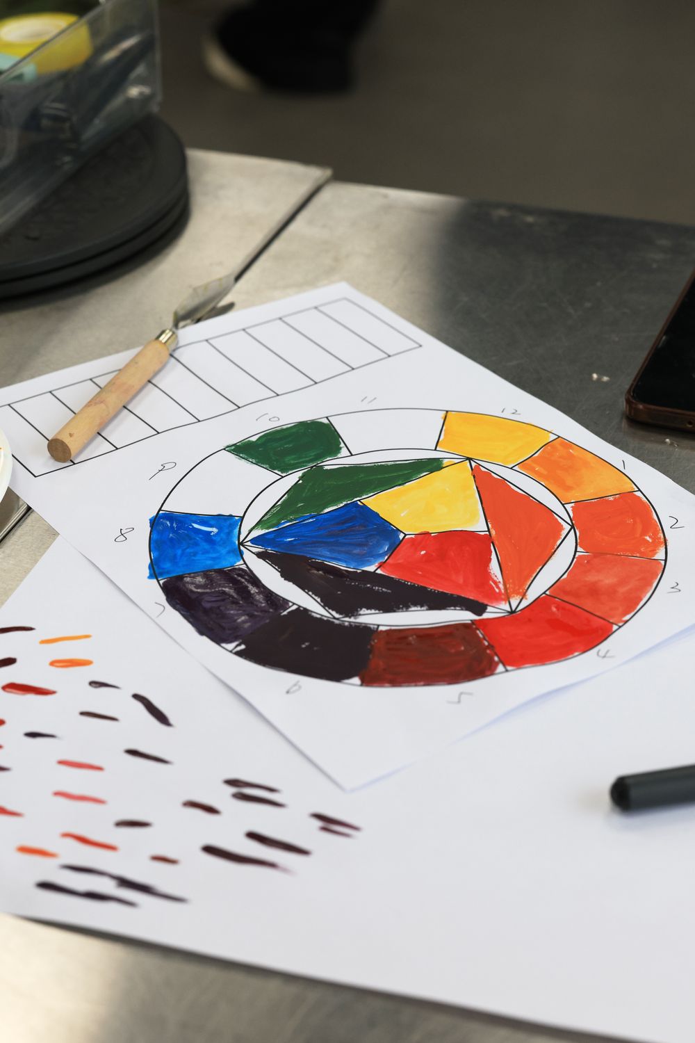 Painting Using Color Wheel Color Wheel with Paint Samples and Artistic Tools · Free Stock Photo