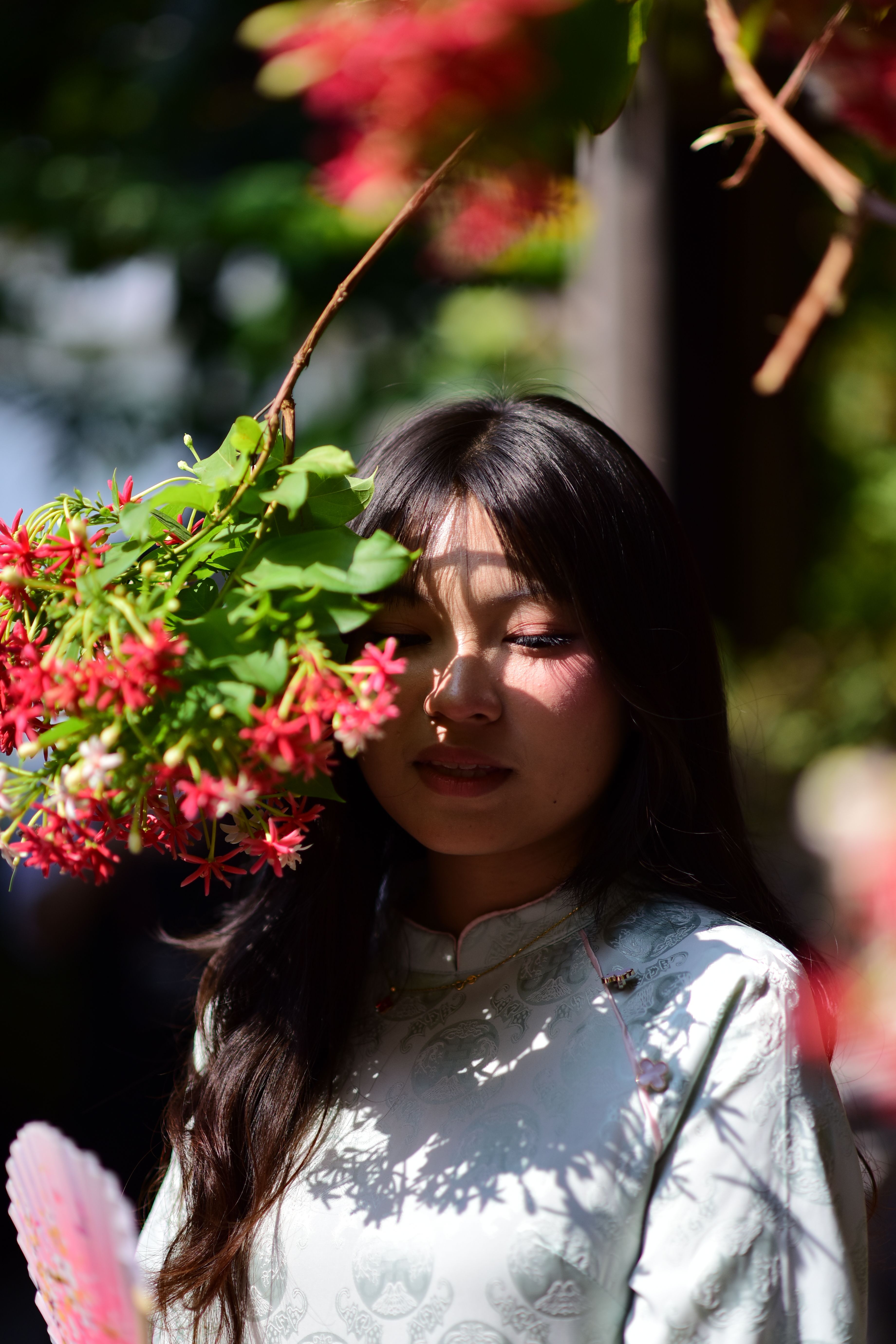 Young woman in traditional dress with flowers outdoors · Free Stock Photo