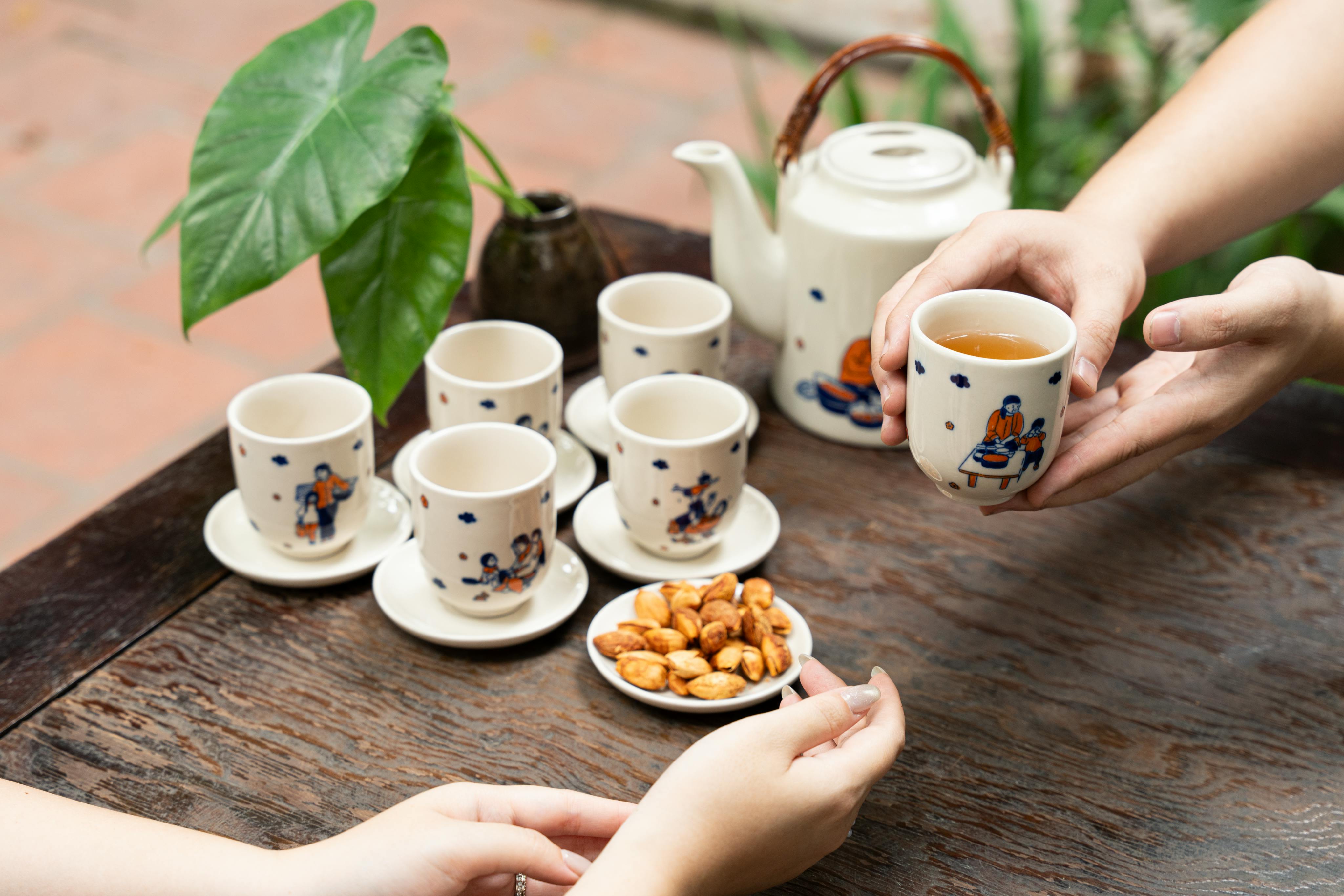 Relaxing tea break with ceramic cups and snacks in a garden setting, emphasizing warmth and hospitality.