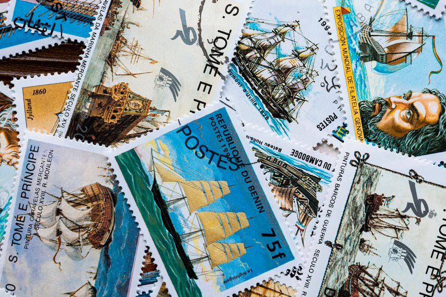 A detailed view of vintage ship-themed stamps from various countries, showcasing nautical history.