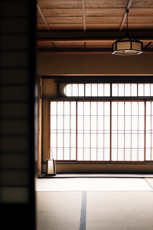 Free Peaceful interior of a traditional Japanese tatami room with a large window. Stock Photo