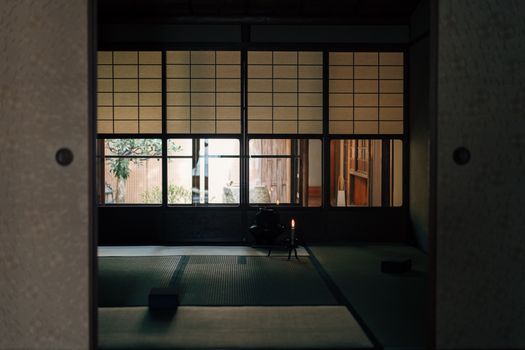 Serene Japanese room featuring tatami mats and Shoji screens, perfect for meditation or tea ceremony.