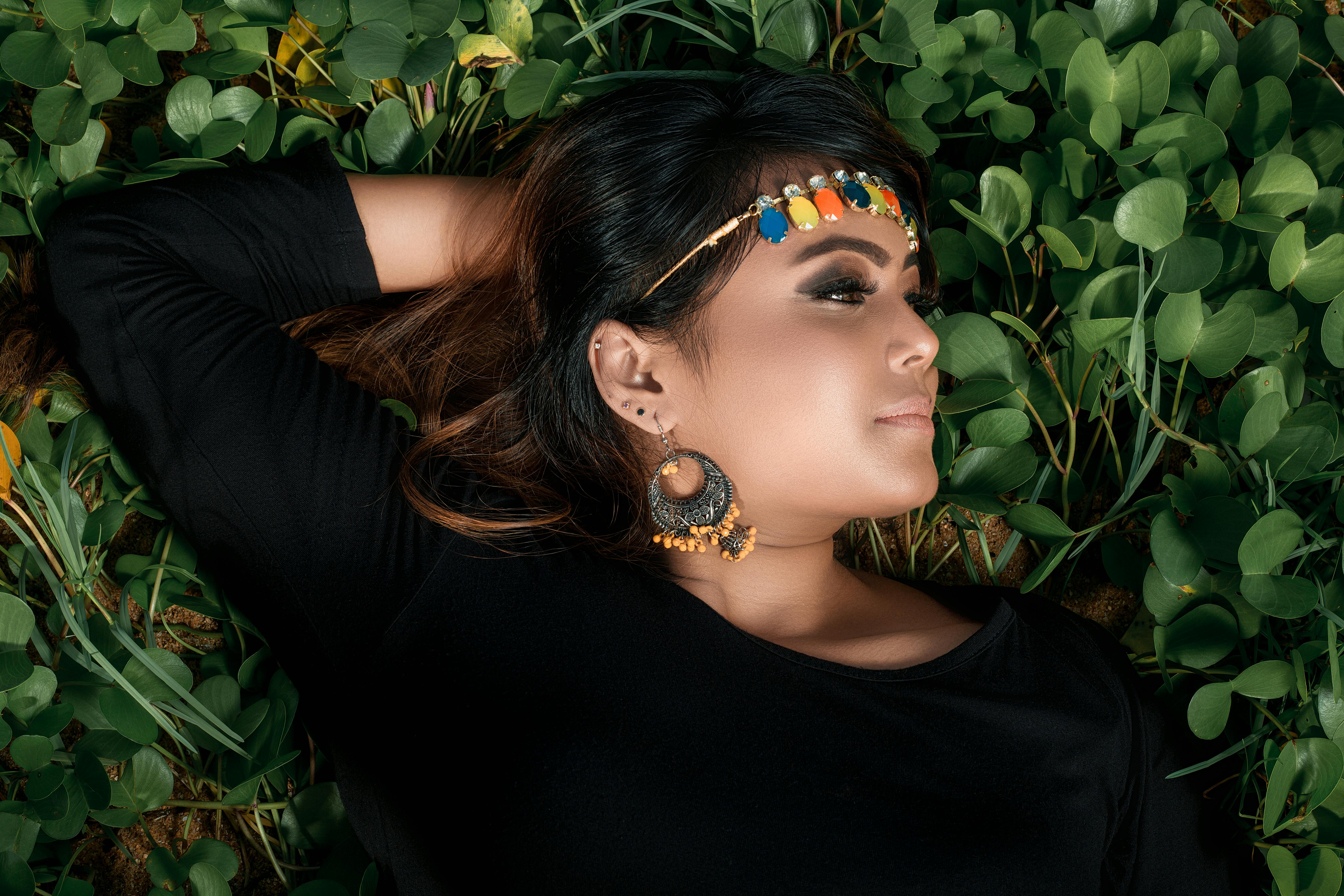 woman lying on green plants