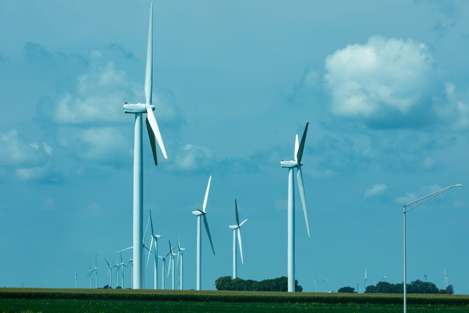 Ameren (AEE): Data Center Boom Meets Regulatory Reality — A Deep Dive 4 Explore a serene landscape of wind turbines in Illinois, capturing renewable energy against a bright, cloudy sky.
