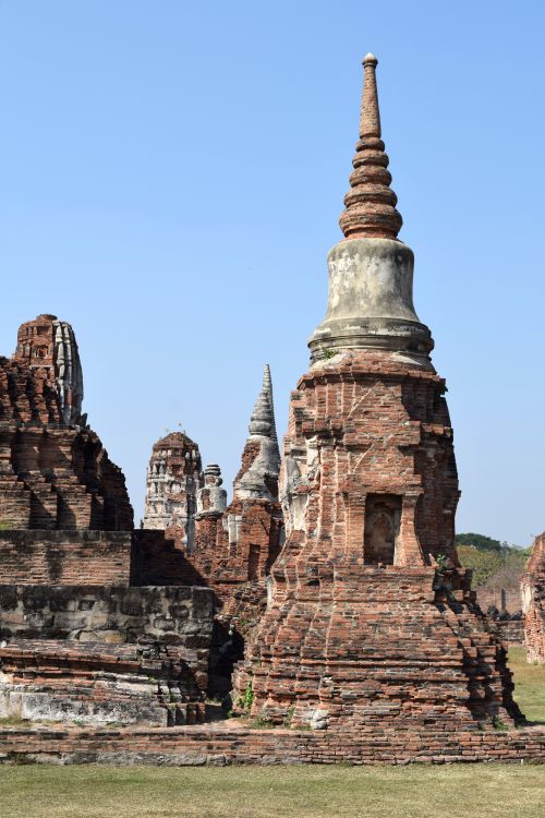 Free Explore the historic Ayutthaya temple ruins with ancient architecture against a clear blue sky. Stock Photo