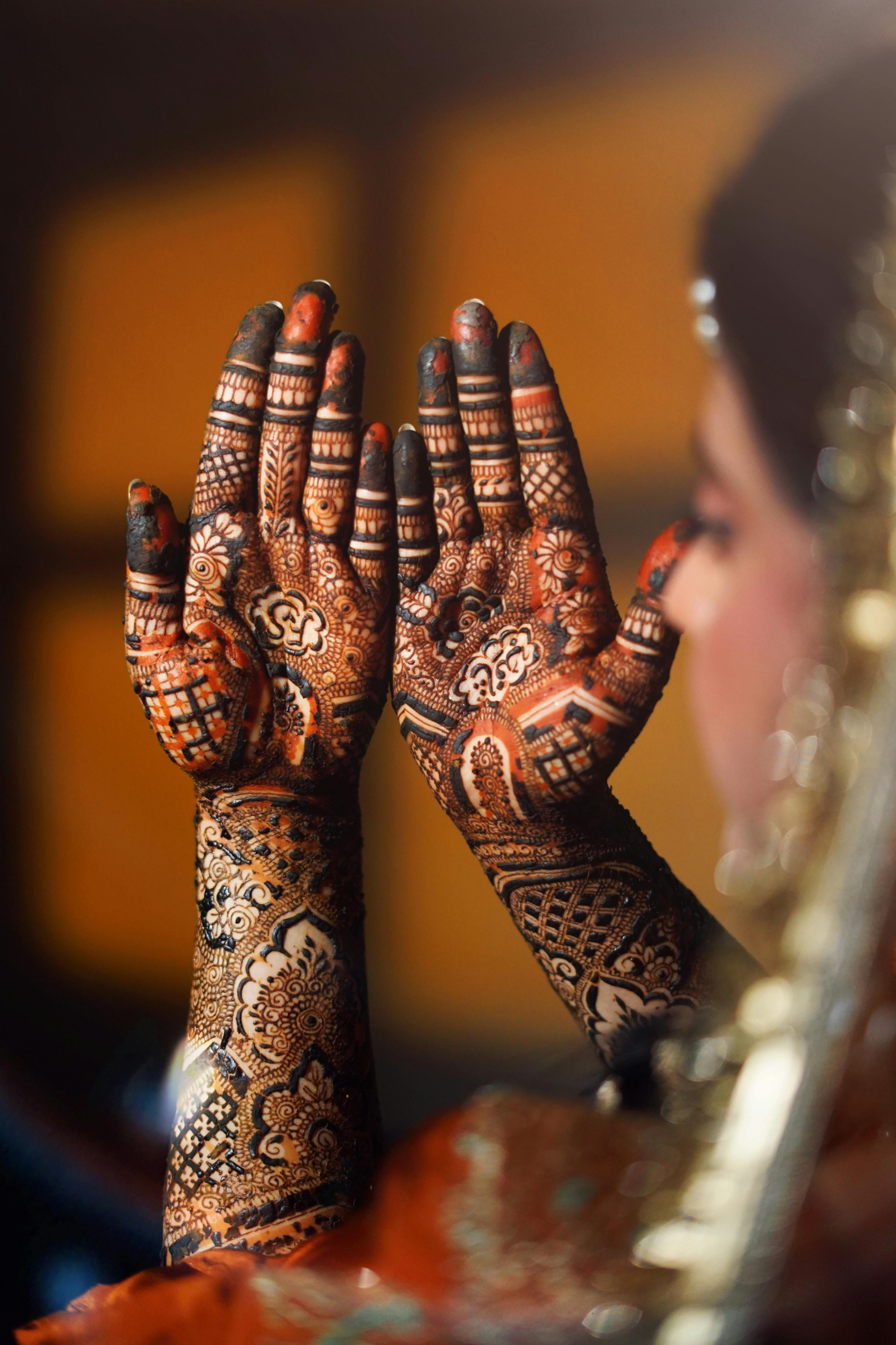 Detailed bride hands with intricate mehendi design, perfect for wedding themes.