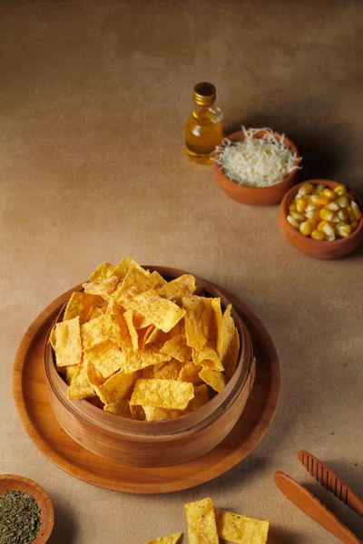 Corn chips in a wooden bowl, photo by Henny Wiyanti on Pexels