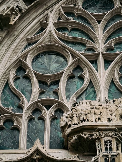 Free Detailed view of Gothic stained glass windows in Nantes, France, showcasing intricate religious carvings. Stock Photo