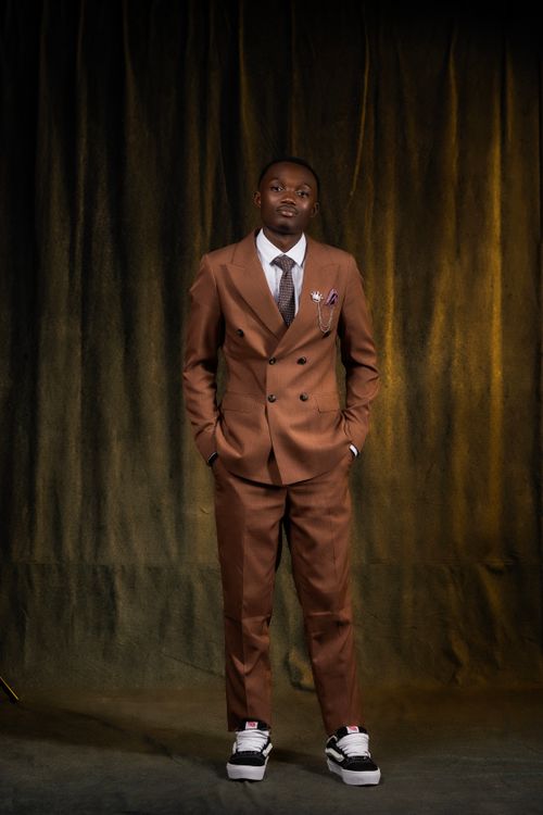 Free Elegant portrait of a fashionable man in a suit and sneakers. Stock Photo