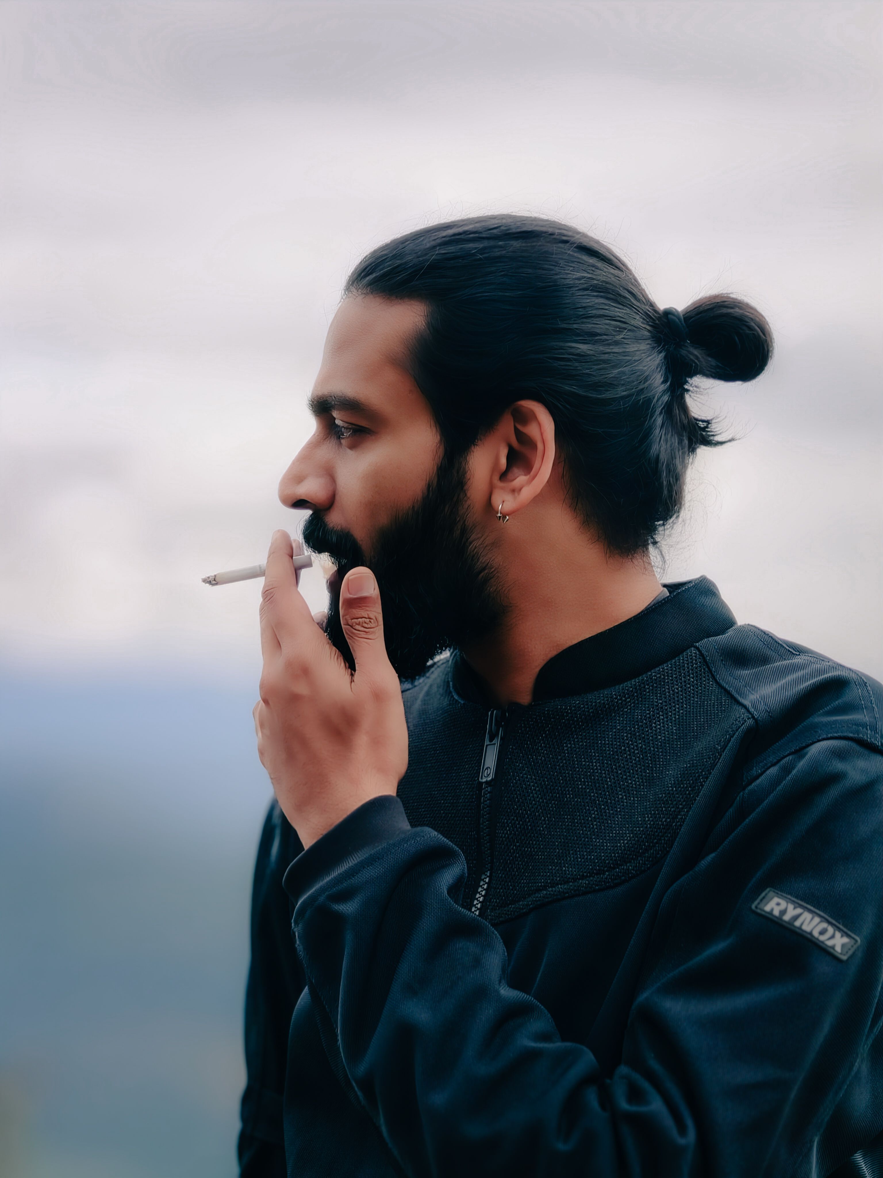 Contemplative Man Smoking in Kerala Outdoors · Free Stock Photo