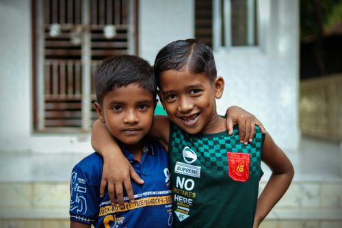 Free Two young boys embracing with joy and friendship in an outdoor setting, capturing the spirit of childhood. Stock Photo