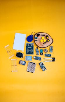 A collection of electronic components arranged on a vibrant yellow surface, ideal for tech enthusiasts.