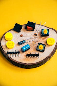 Assorted electronic components on a wooden base. Perfect for robotics and electronics projects.